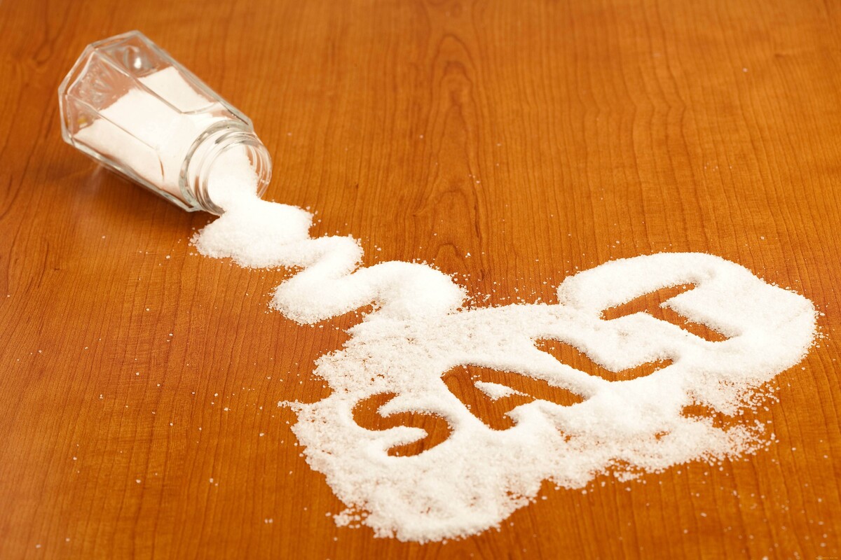 An image of a saltshaker that has been spilled, which has a word that spells "Salt".